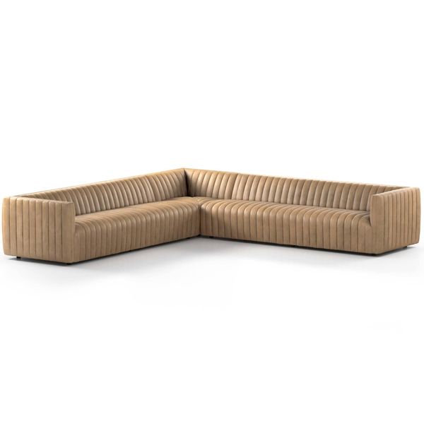 Sofa narozna o zaokraglonej formie z oszczednym detalem w odcieniu bezu