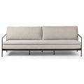 Sofa tapicerowana o spokojnej linii z oszczednym detalem w odcieniu bieli