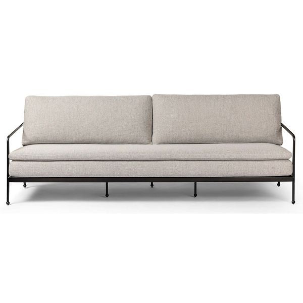 Sofa tapicerowana o spokojnej linii z oszczednym detalem w odcieniu bieli
